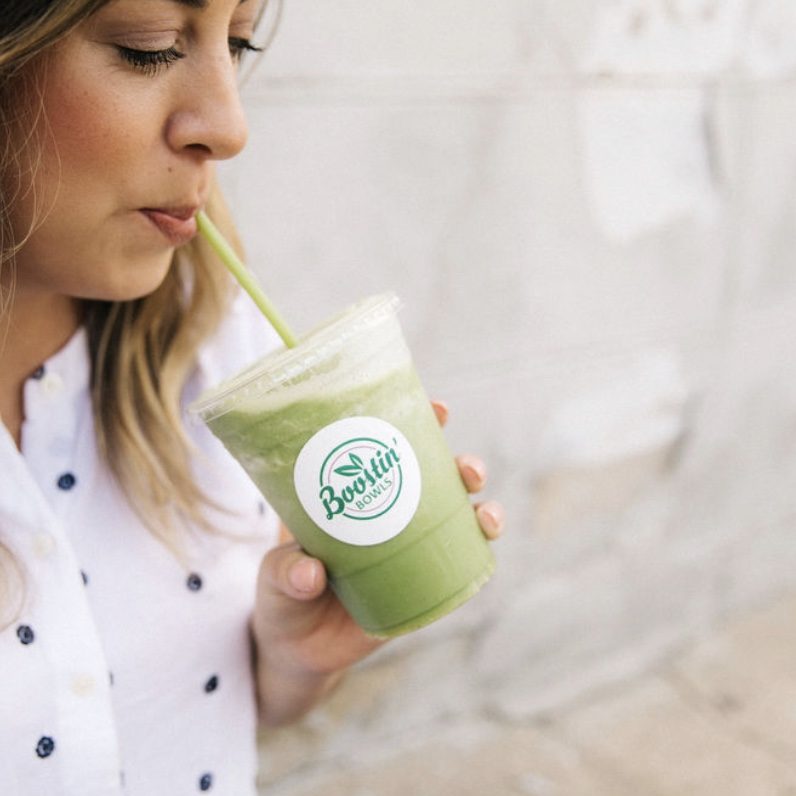 Lexie sipping a green smoothie