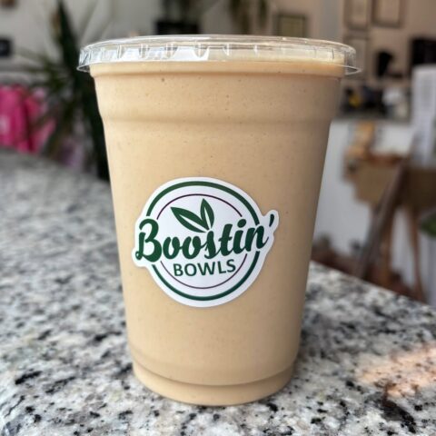 Beige smoothie with almond milk, banana, peanut butter, and honey