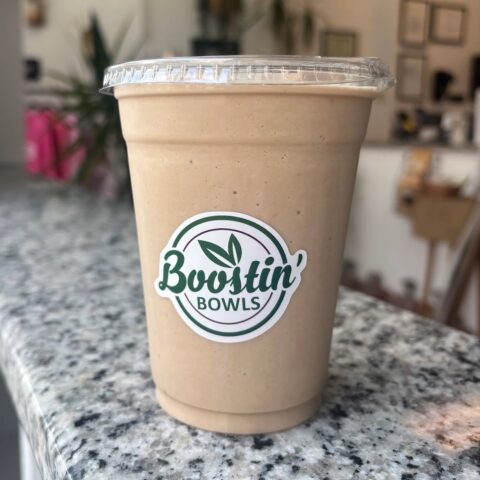 Brown smoothie with almond milk, banana, peanut butter, and protein
